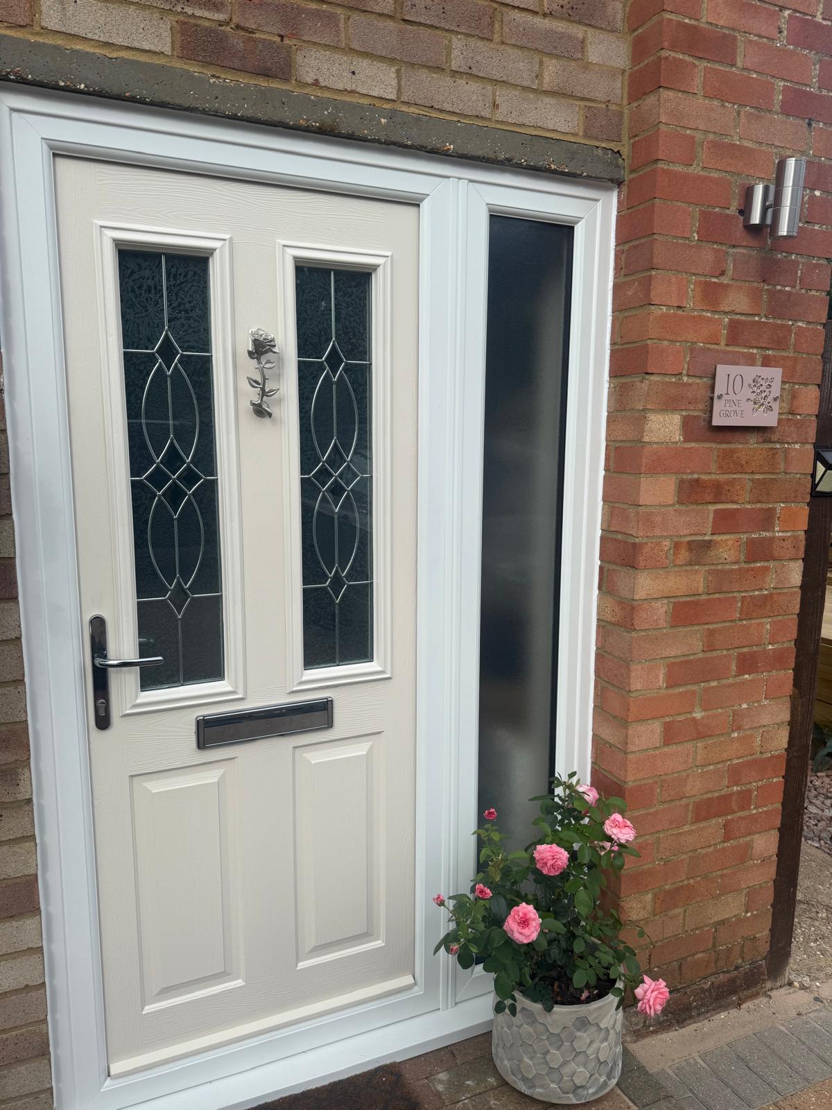 White composite door with ornate leaded glazing and sidelight