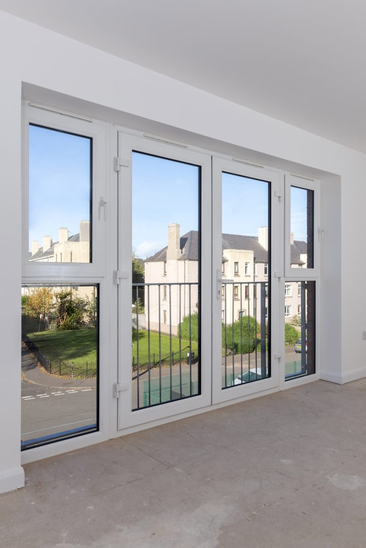 White french doors viewed from inside a bright room