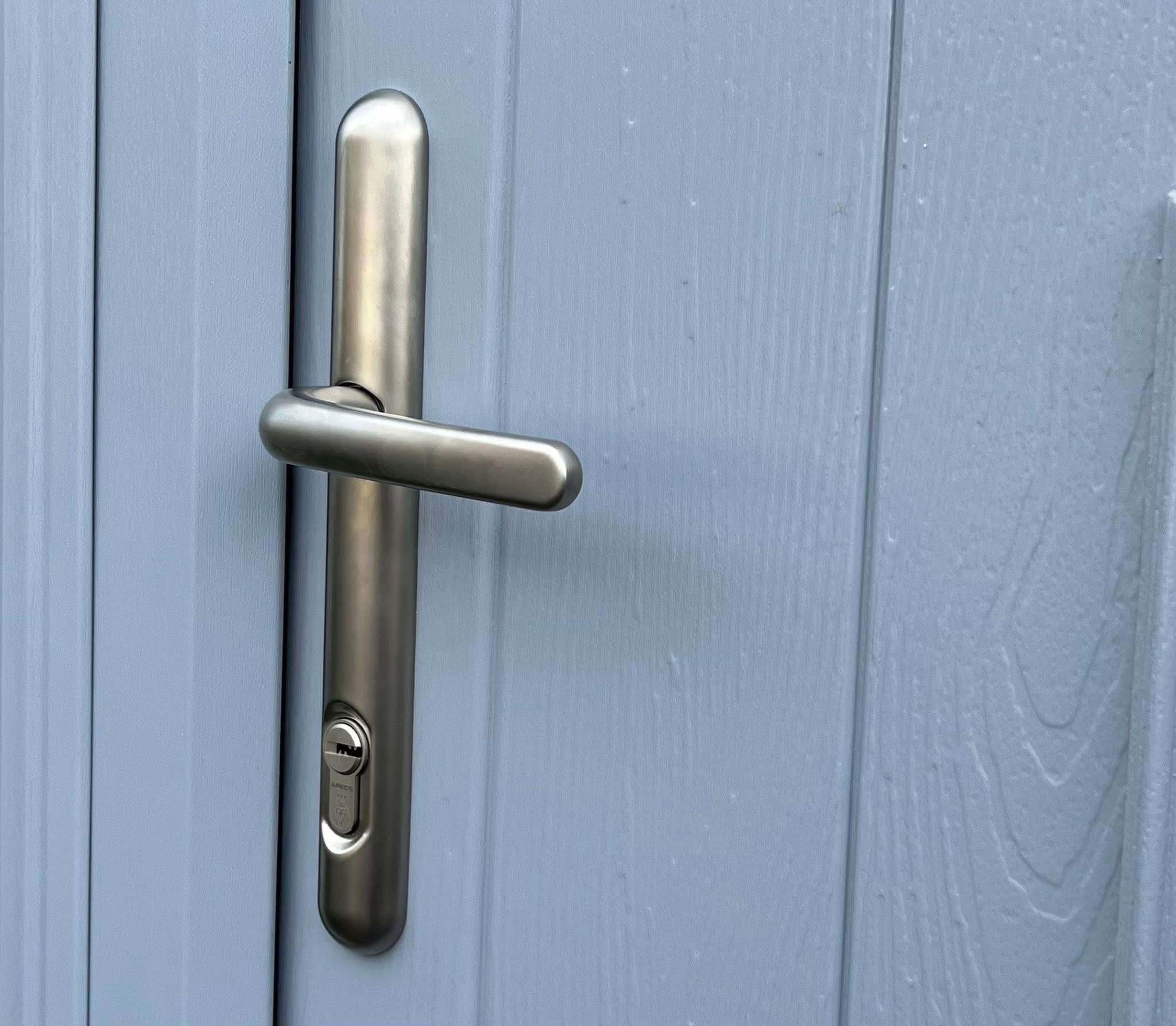 Close-up of a multi-point door handle and lock cylinder on a composite door