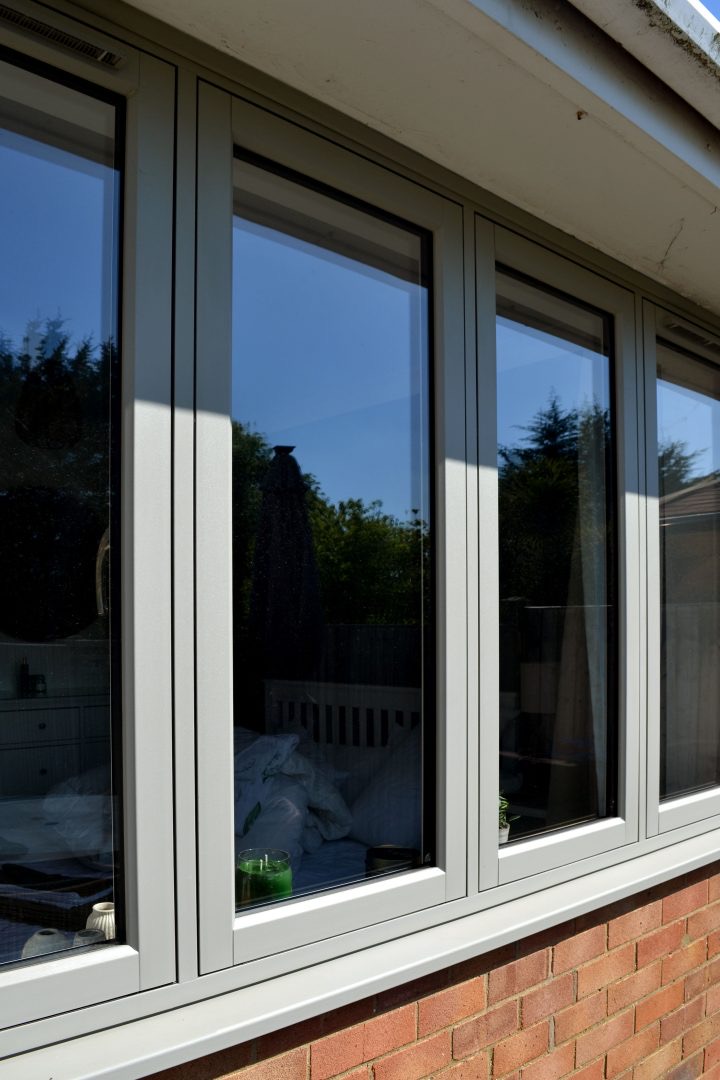 Grey flush casement windows viewed at an angle