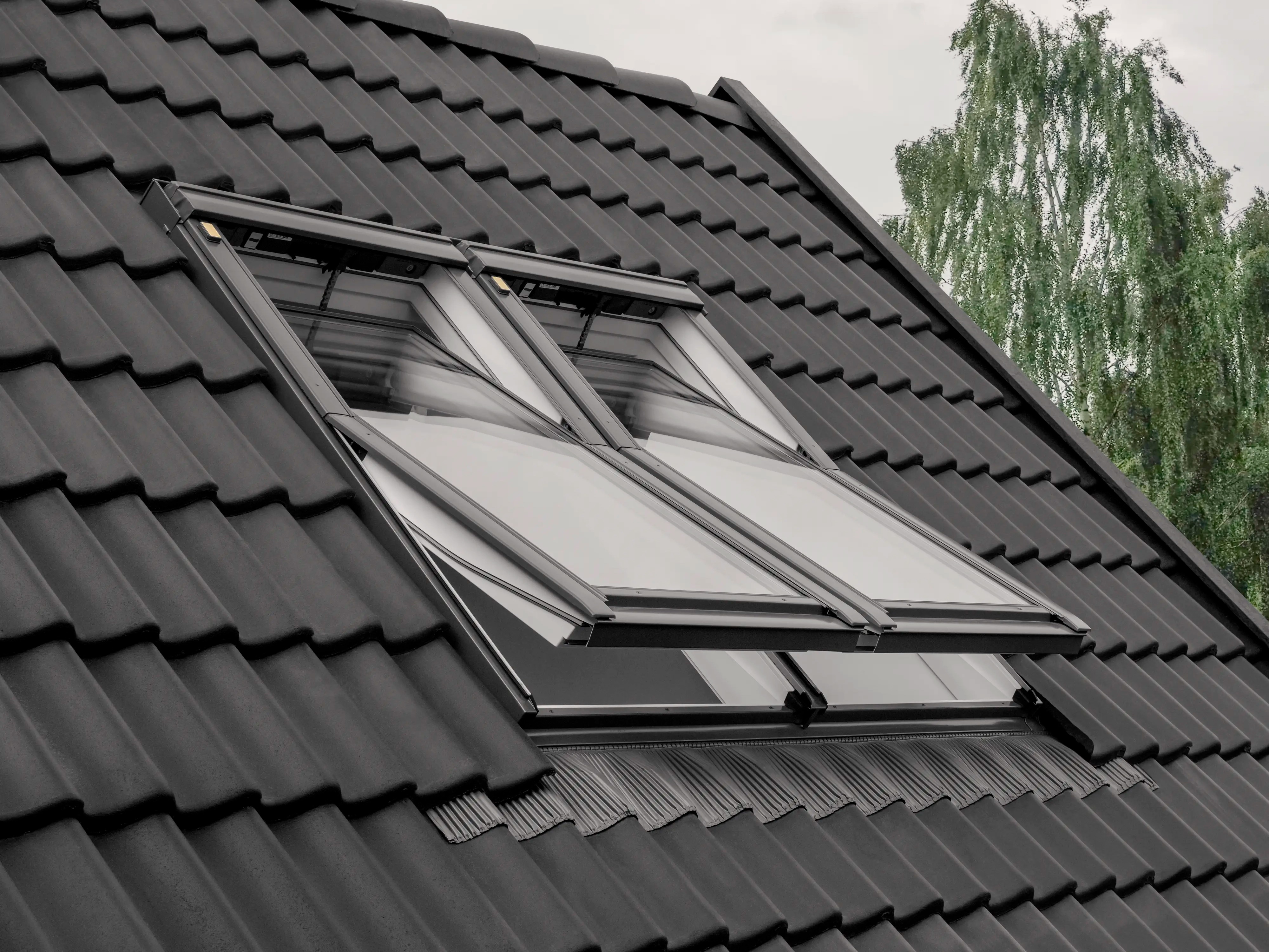 Velux roof windows open on a tiled roof